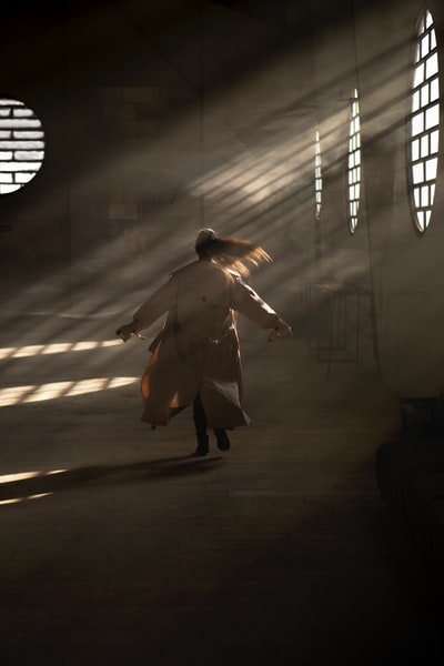 man in white coat walking on tunnel